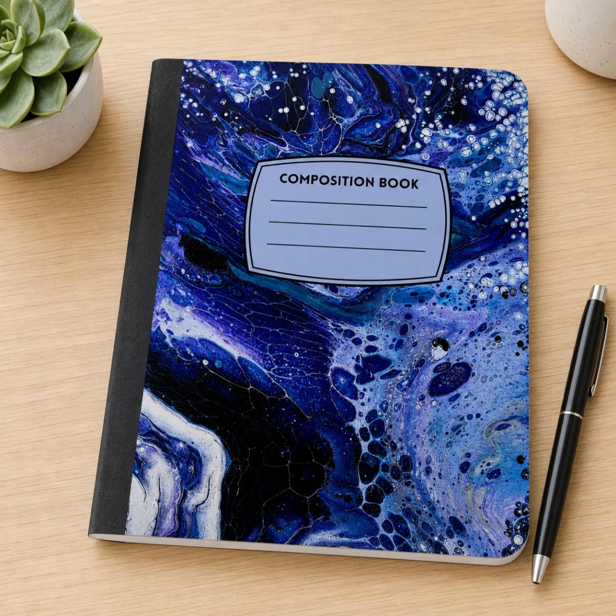 Midnight Ocean acrylic pour art composition notebook on a desk
